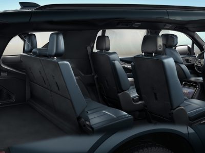 2026 Cadillac ESCALADE IQL Rear cutaway view of the Cadillac ESCALADE IQL with Harbor Blue interior showcasing 3rd row seating and rear cargo space.